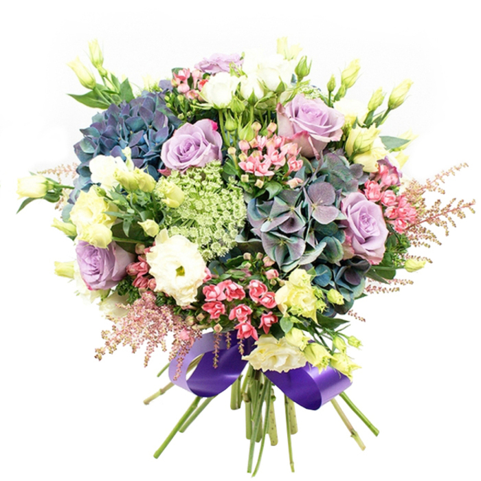 Bursting with fresh energy and overflowing blooms, this intricately crafted bouquet captures the diverse character of Forest Gate, echoing the vibrant life along Romford Road and the leafy calm of Wanstead Flats. Prominent, voluminous hydrangeas display deep indigo, teal, and purple hues, providing a bold foundation that draws the eye. These majestic clusters are interspersed with roses in gentle whispers of lilac, lavender, and classic creamy white, each bloom expertly arranged to complement the overall palette and add soft, elegant allure. White ranunculus flowers, their layers of ruffled petals gleaming with purity, introduce a cloudlike softness, balanced by the structure and height offered by slender pale yellow eustoma buds and partially opened blossoms. Throughout the arrangement, vivid sprays of fuchsia-pink filler flowers deliver lively pops of brightness, while ethereal pale pink astilbe plumes soften the bouquet's outline and infuse a sense of whimsical movement. Lacy green and white blooms-possibly Ammi Majus-are woven artfully between the major elements, enriching the textural tapestry. The entire bouquet is grounded by a backdrop of lush, dark green foliage that enhances the freshness and depth of the colours. At the base, stems are neatly tied, finished in a sumptuous royal purple satin ribbon, echoing the bouquet's cool tones and providing a stately, polished accent. This arrangement, perfect for special celebrations, romantic surprises, or elegant centrepieces, speaks to the artistry and dedication of Forest Gate's own Flower Delivery Forest Gate team, delivering floral joy across East London.